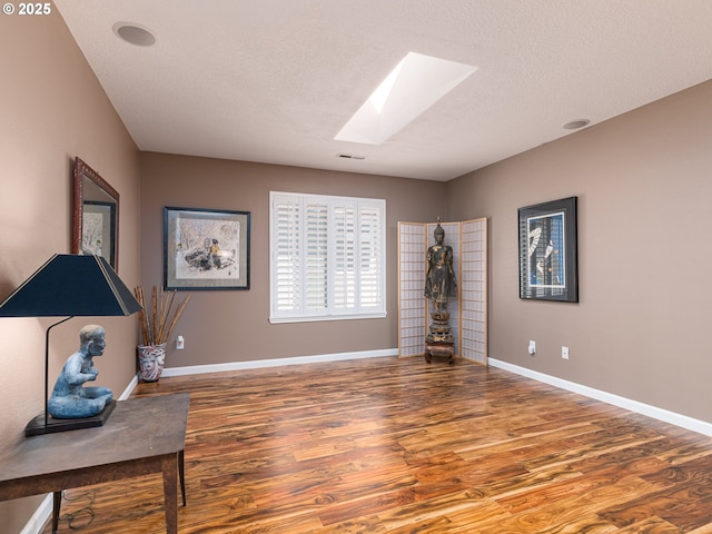 8833 SE Bristol Park Dr, Happy Valley, OR 97086 - sitting room featuring a skylight, wood finished floors, and a textured ceiling