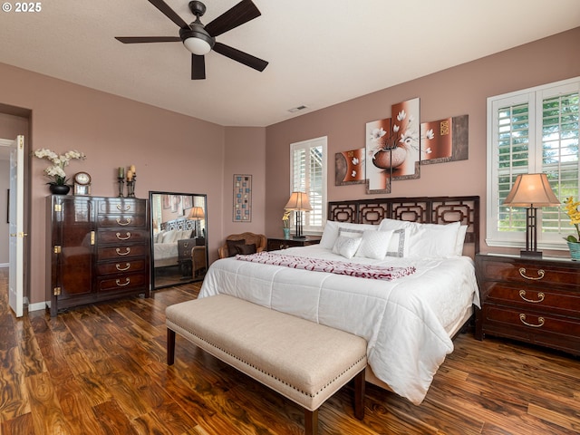 8833 SE Bristol Park Dr, Happy Valley, OR 97086 - bedroom with dark wood-style flooring, multiple windows, and a ceiling fan