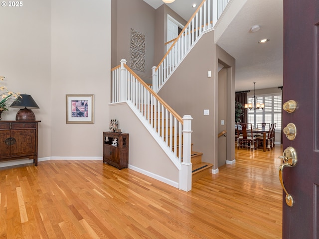 8833 SE Bristol Park Dr, Happy Valley, OR 97086 - foyer entrance featuring light wood-style flooring, a towering ceiling, stairway, a chandelier, and recessed lighting