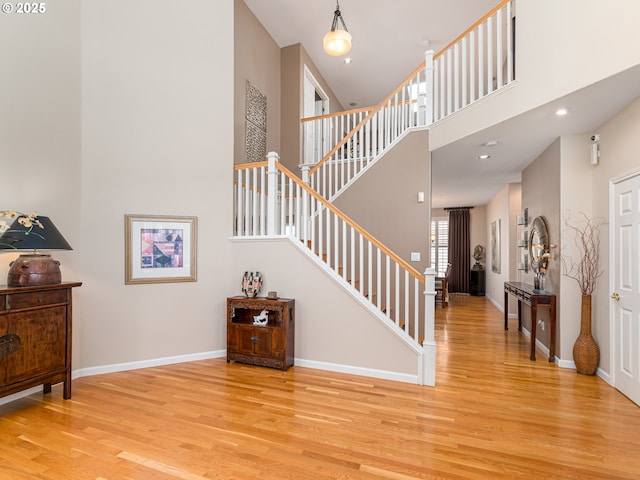 8833 SE Bristol Park Dr, Happy Valley, OR 97086 - stairway featuring wood finished floors, a towering ceiling, and recessed lighting