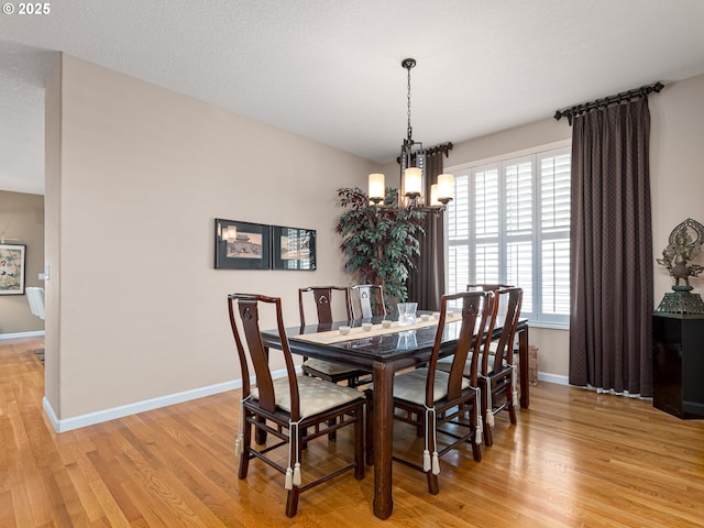 8833 SE Bristol Park Dr, Happy Valley, OR 97086 - dining space featuring a chandelier, light wood-type flooring, and plenty of natural light