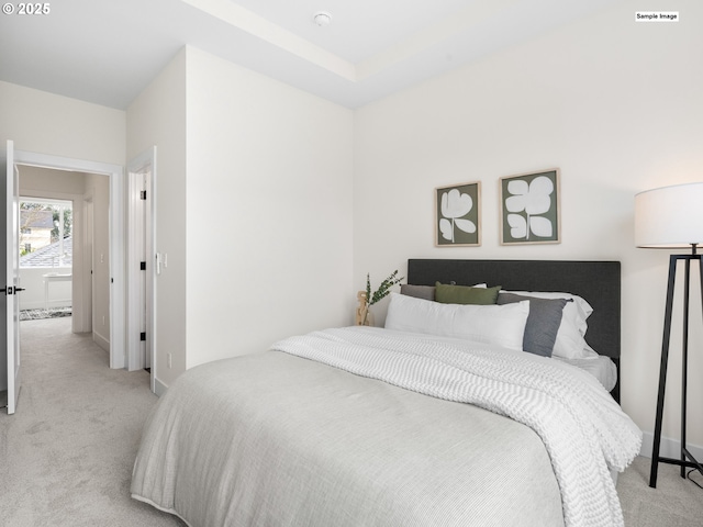 bedroom featuring visible vents, light carpet, and baseboards