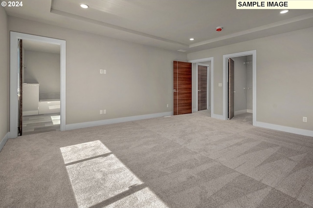12343 SE Falling Rain Way, Happy Valley, OR 97086 - unfurnished bedroom with recessed lighting, a raised ceiling, carpet flooring, ensuite bath, and a walk in closet