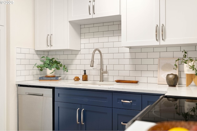 10258 N Allegheny Ave, Portland, OR 97203 - kitchen featuring stainless steel dishwasher, white cabinetry, blue cabinetry, and a sink