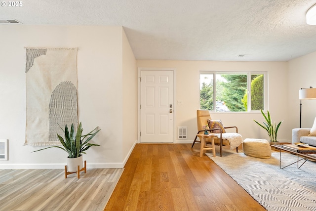 10258 N Allegheny Ave, Portland, OR 97203 - foyer with light wood-type flooring, a textured ceiling, and baseboards