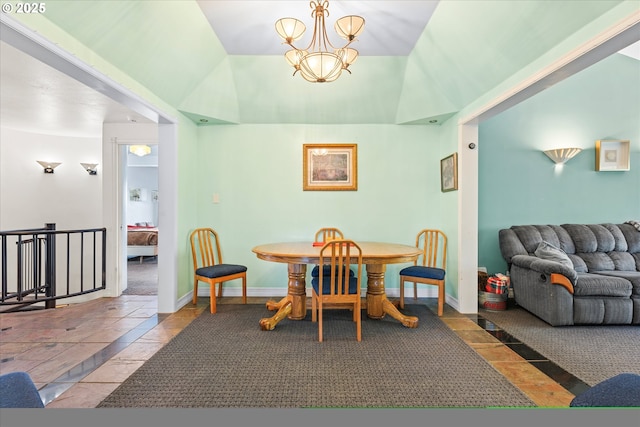 dining space with lofted ceiling and a chandelier