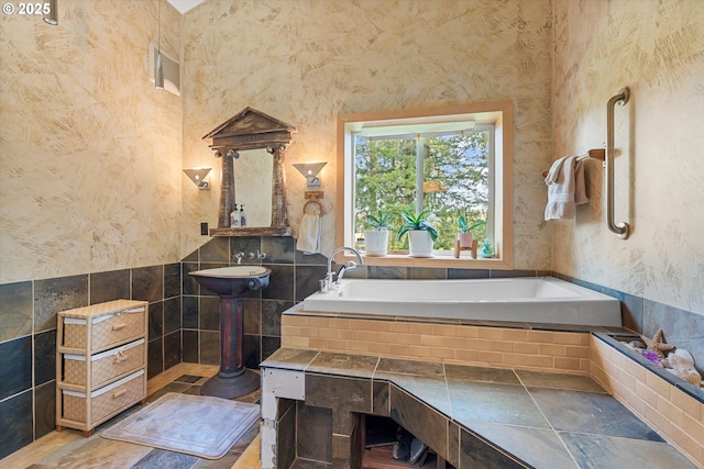 bathroom featuring tile walls and tiled tub