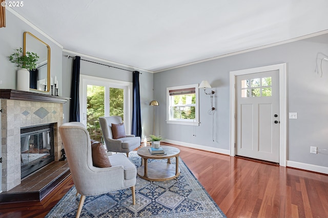 3915 SE Lambert St, Portland, OR 97202 - living area with crown molding, baseboards, wood finished floors, and a tiled fireplace