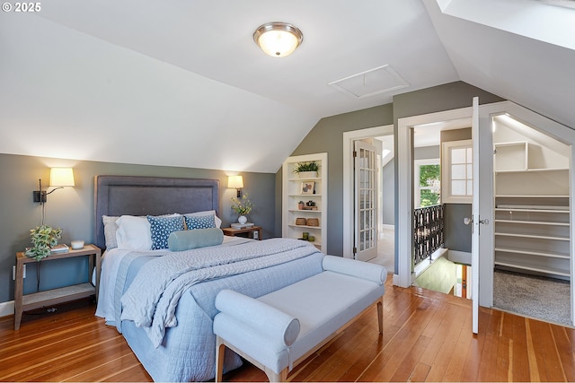 3915 SE Lambert St, Portland, OR 97202 - bedroom with hardwood / wood-style floors, vaulted ceiling, and baseboards