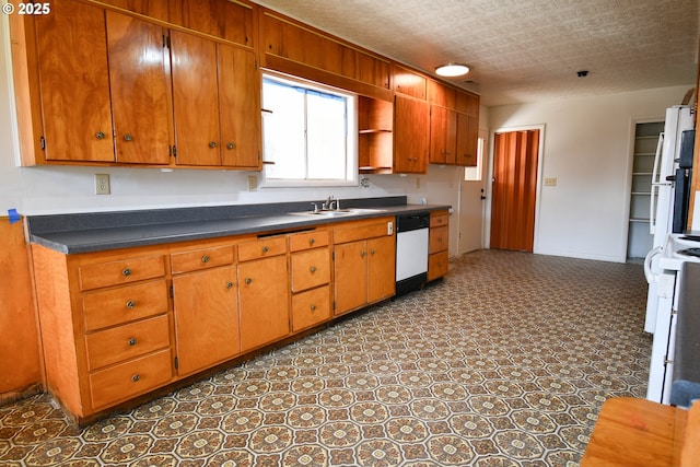 151 NW Sherry St, Winston, OR 97496 - kitchen with range, dishwasher, sink, and a textured ceiling