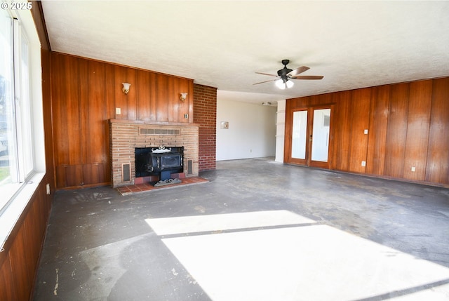 151 NW Sherry St, Winston, OR 97496 - unfurnished living room with french doors, ceiling fan, and wood walls