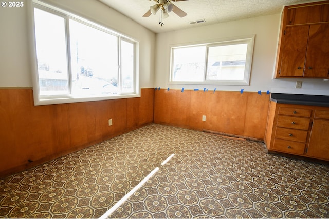 151 NW Sherry St, Winston, OR 97496 - interior space featuring a textured ceiling, wooden walls, and ceiling fan