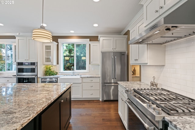 kitchen featuring under cabinet range hood, appliances with stainless steel finishes, a wealth of natural light, and a sink