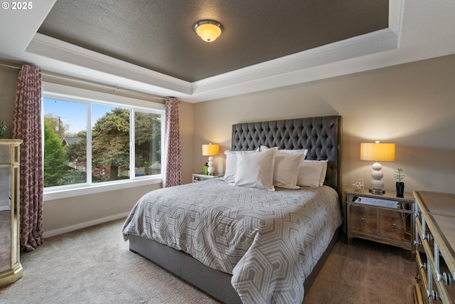 bedroom featuring baseboards, a tray ceiling, and carpet flooring