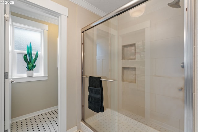 full bath featuring crown molding, baseboards, and a shower stall