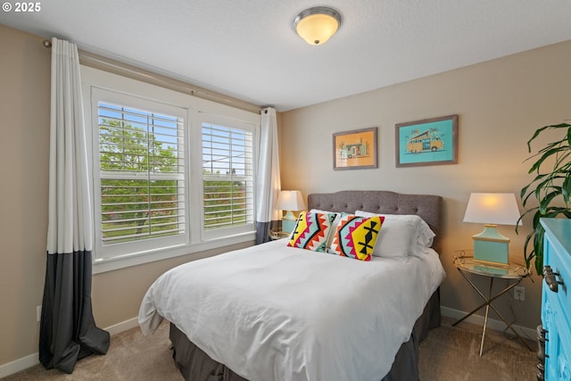 carpeted bedroom with baseboards