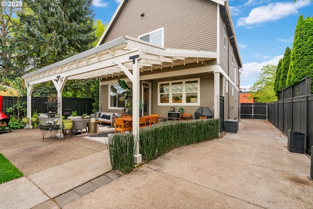 rear view of property featuring a fenced backyard, outdoor lounge area, and a patio area