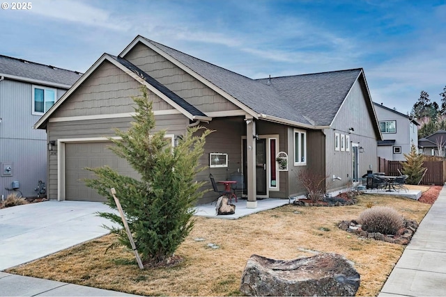 view of front of property featuring a garage and a patio area