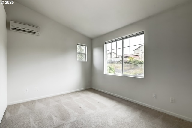 carpeted empty room featuring a wall mounted AC, baseboards, and lofted ceiling