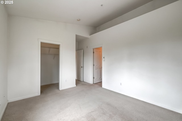 unfurnished bedroom featuring carpet floors, baseboards, and a closet