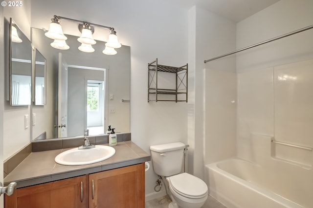 bathroom with toilet, vanity, and shower / bathtub combination