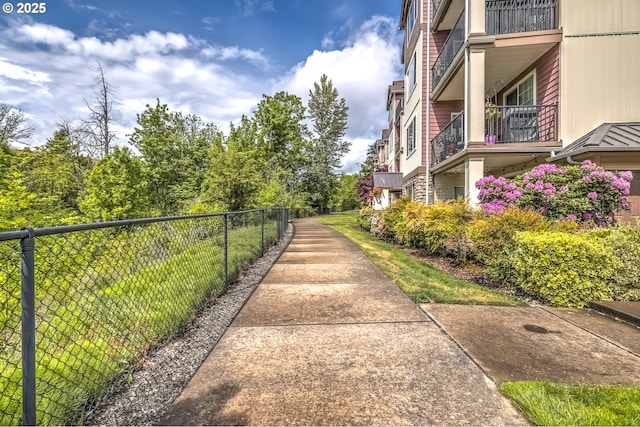 view of property's community featuring fence