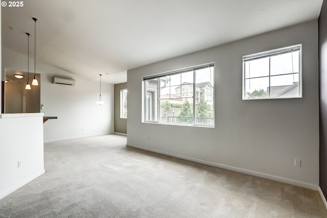 empty room with a wall mounted air conditioner, carpet, baseboards, and lofted ceiling