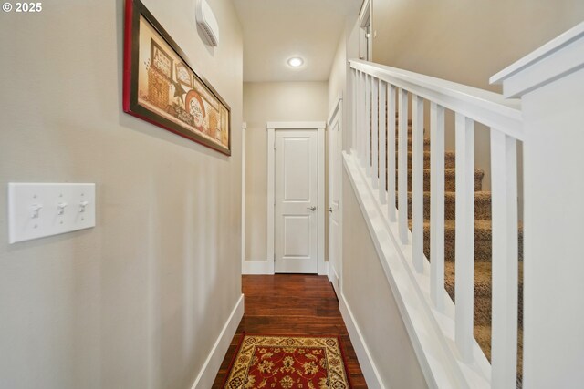 corridor with recessed lighting, baseboards, and dark wood-type flooring