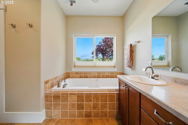 bathroom with vanity and a garden tub