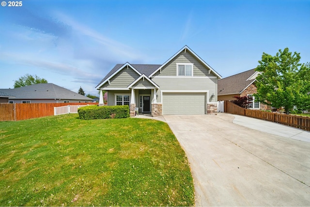 craftsman-style house featuring stone siding, fence, driveway, and a front yard