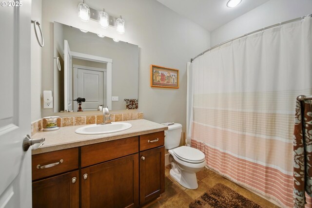 full bath featuring vanity and toilet