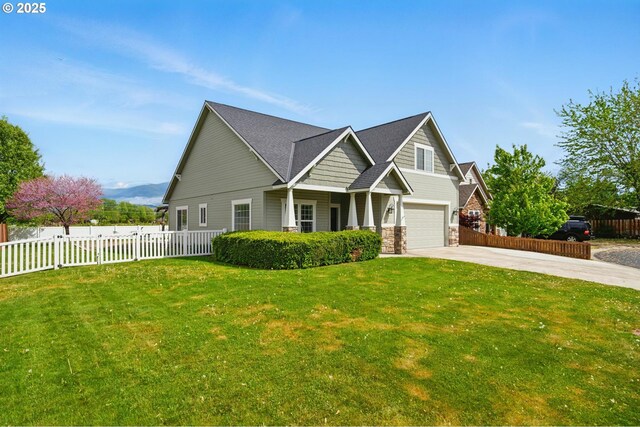 craftsman-style home featuring a garage, fence, a front yard, and concrete driveway