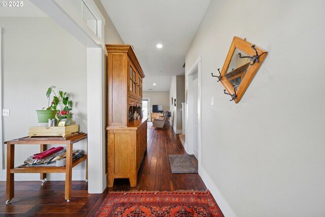 corridor with recessed lighting, dark wood-style flooring, and baseboards