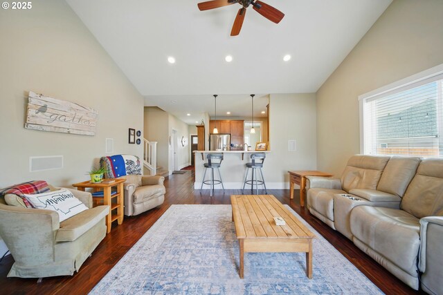 living room featuring a ceiling fan, dark wood-style flooring, high vaulted ceiling, baseboards, and recessed lighting