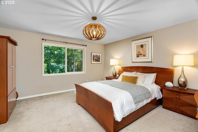 885 NW Torrey View Ln, Portland, OR 97229 - carpeted bedroom with baseboards and a chandelier