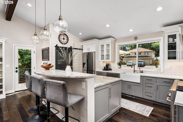 885 NW Torrey View Ln, Portland, OR 97229 - kitchen featuring stainless steel appliances, gray cabinets, a sink, light stone countertops, and dark wood-style floors