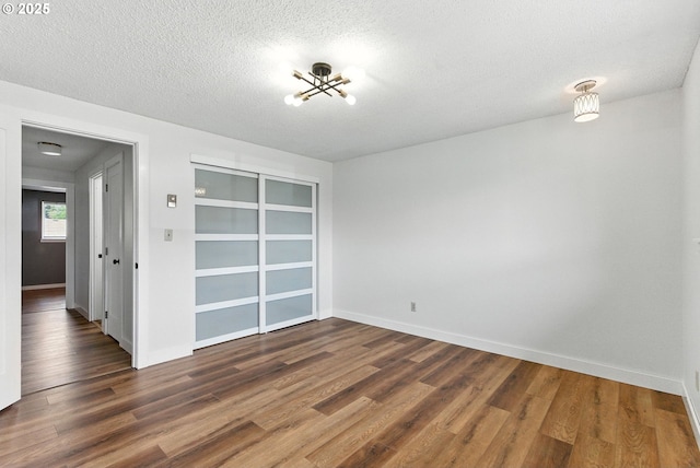 7631 SE Thompson Rd, Milwaukie, OR 97222 - unfurnished dining area featuring wood finished floors, a textured ceiling, and a chandelier
