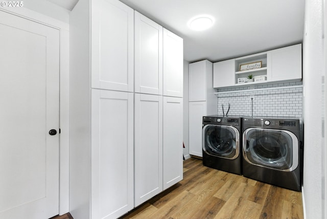 7631 SE Thompson Rd, Milwaukie, OR 97222 - washroom with cabinet space, washer and clothes dryer, and wood finished floors