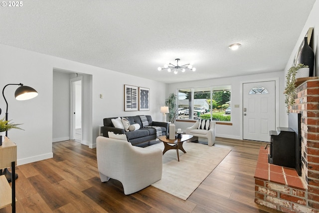 7631 SE Thompson Rd, Milwaukie, OR 97222 - living room featuring wood finished floors, a textured ceiling, and a chandelier