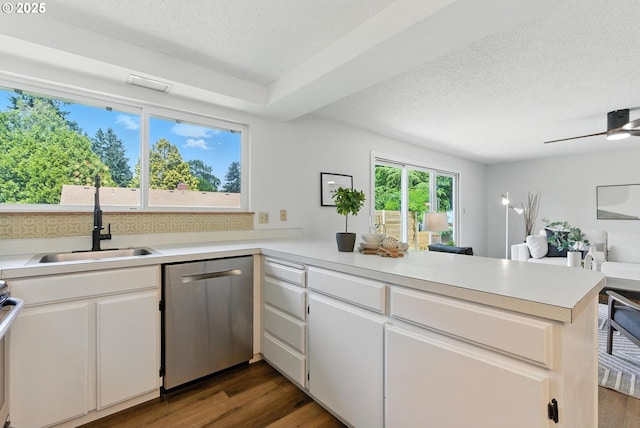 7631 SE Thompson Rd, Milwaukie, OR 97222 - kitchen featuring stainless steel dishwasher, a peninsula, a textured ceiling, light countertops, and plenty of natural light