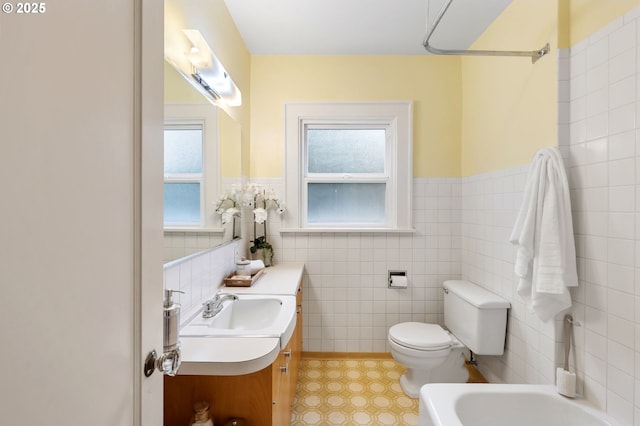 6116 SE 36th Ave, Portland, OR 97202 - full bath with plenty of natural light, toilet, tile walls, vanity, and a wainscoted wall