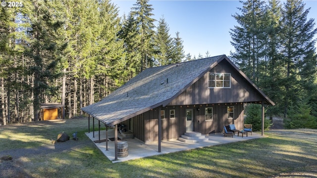 back of property with a patio and a yard