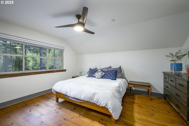 bedroom featuring hardwood / wood-style flooring, lofted ceiling, and ceiling fan