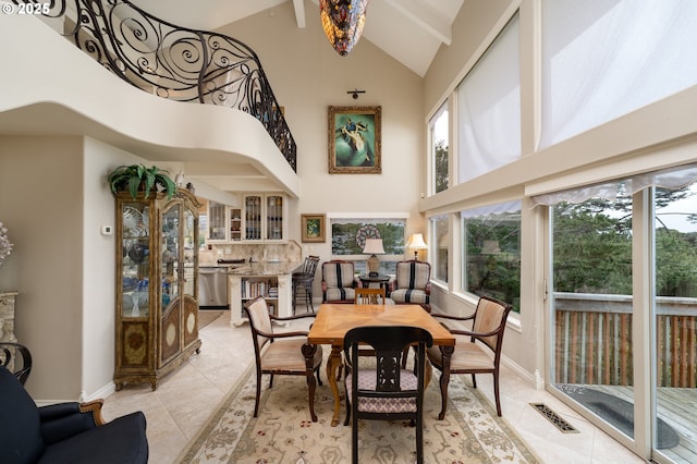 tiled dining space featuring high vaulted ceiling