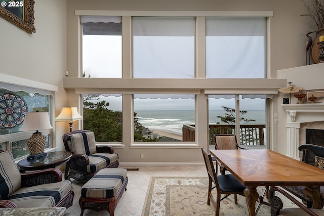 interior space with a high ceiling, a water view, and a healthy amount of sunlight