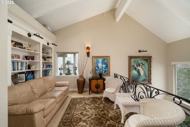 living area featuring a wealth of natural light, lofted ceiling with beams, and carpet