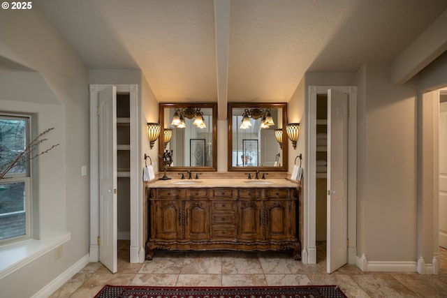 bathroom featuring vanity, a notable chandelier, and a textured ceiling