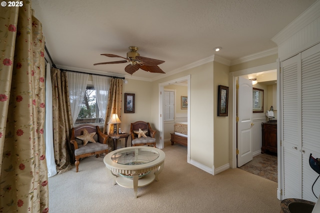 sitting room featuring crown molding, light colored carpet, ceiling fan, and a textured ceiling