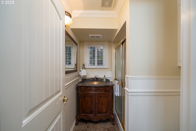 bathroom featuring crown molding and vanity