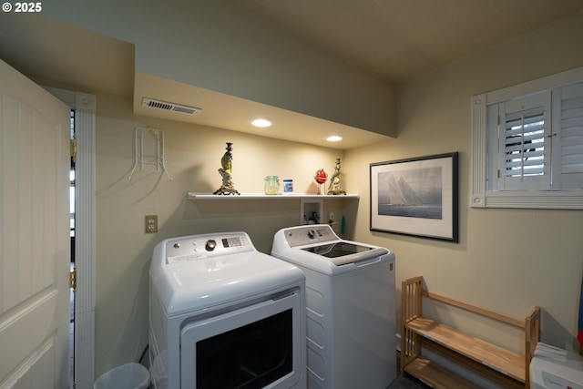 clothes washing area featuring separate washer and dryer